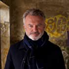 Sam Neill به عنوان Dennis Tanner