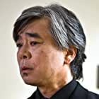 Denis Akiyama به عنوان Professor Iwatani