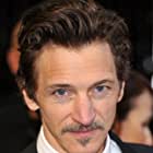 John Hawkes به عنوان Roger