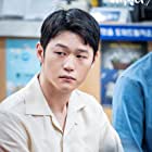 Hak-joo Lee به عنوان Kim Sang-beom (2018)